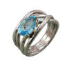 Anello intreccio topazio azzurro sinistra